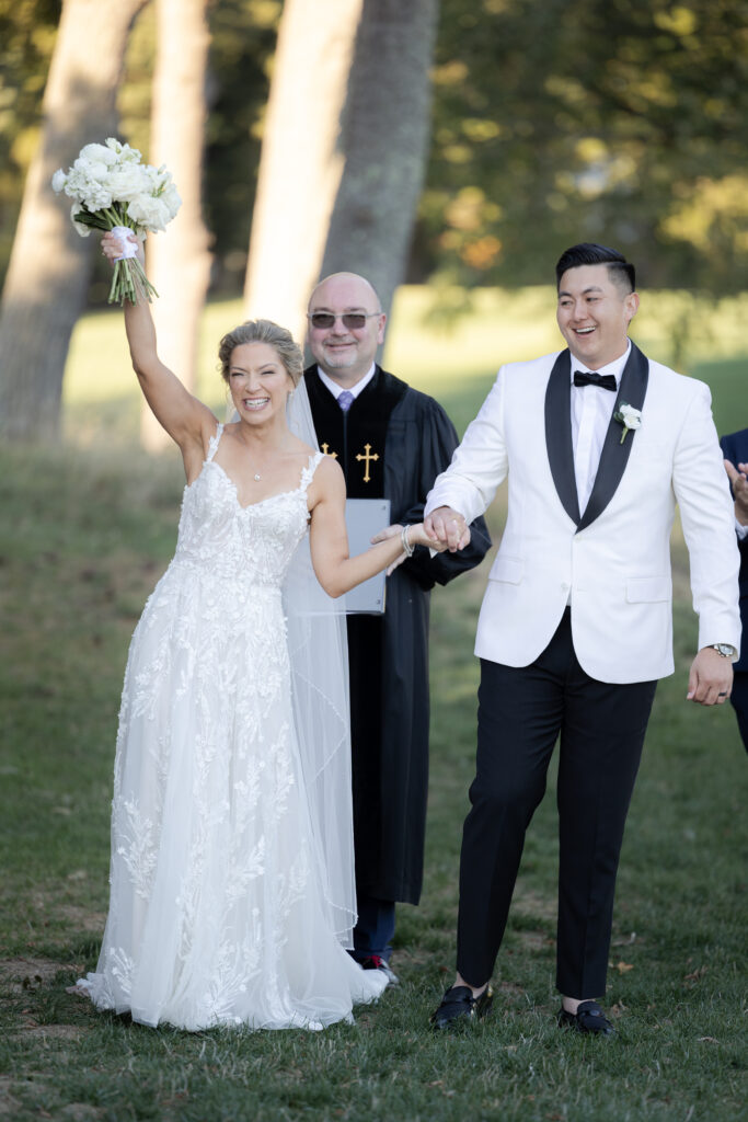 Bride and groom just married walking down aisle at wedding ceremony