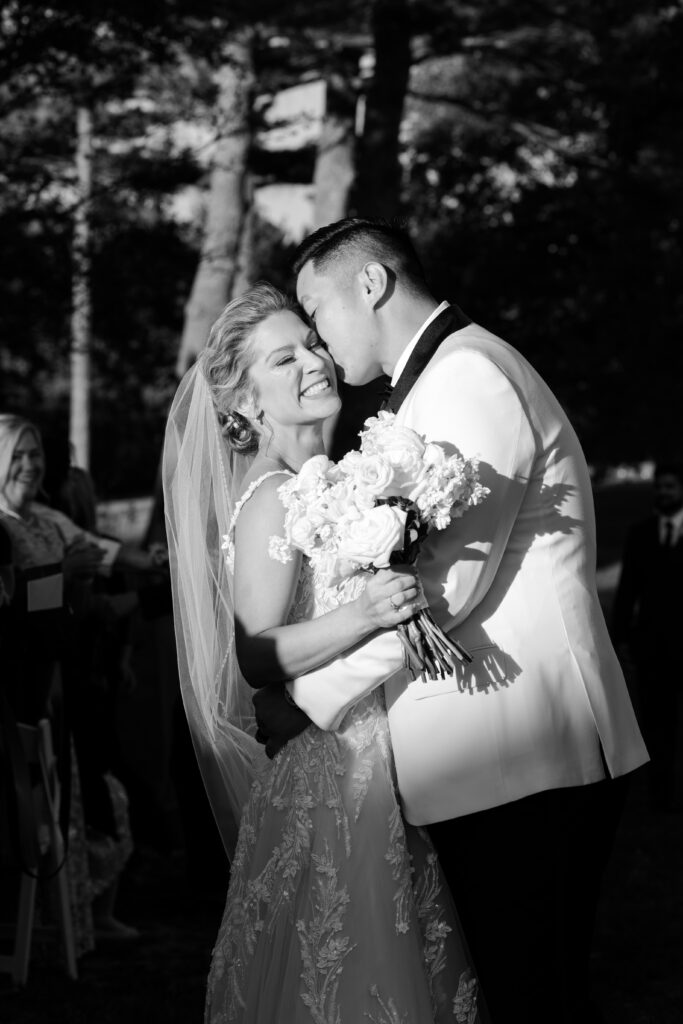 Bride and groom just married aisle kiss at wedding ceremony