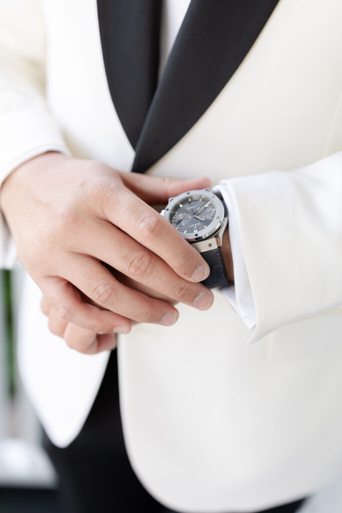 Groom fixing wedding watch