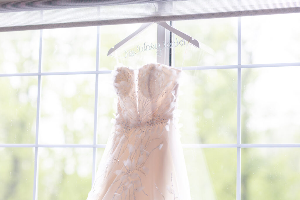 Bride and mom getting wedding gown on