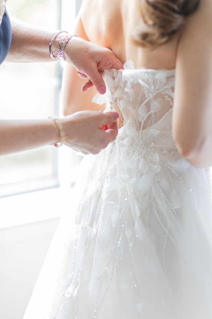 Mom putting bride's veil on