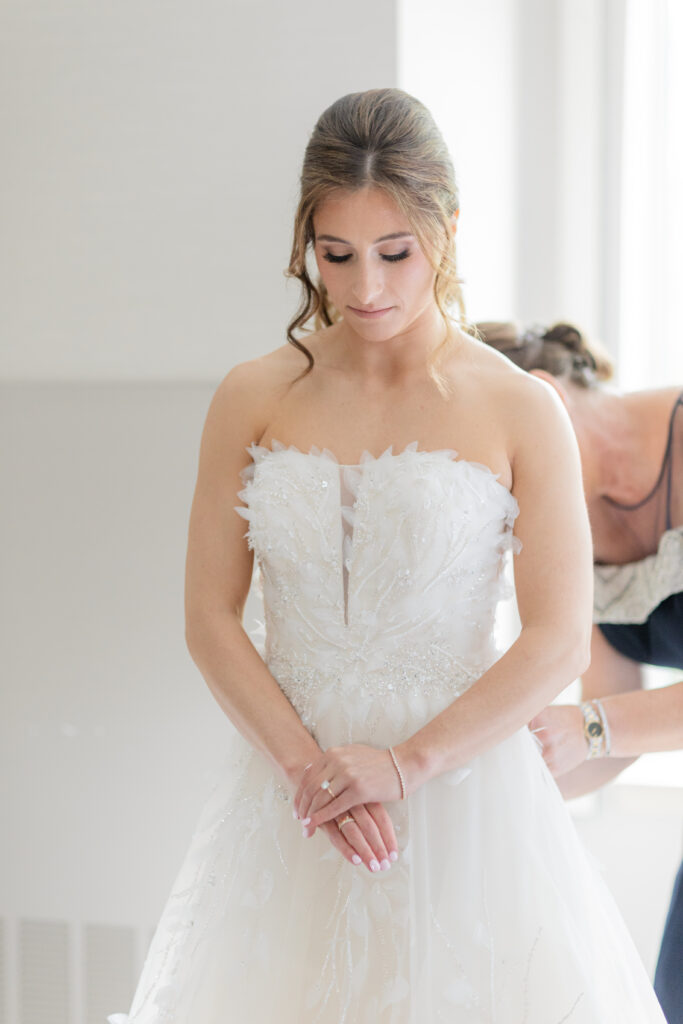 Mom putting bride's veil on