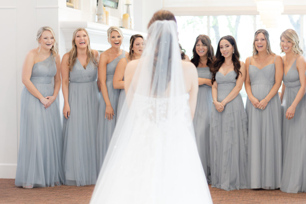 Bridesmaid first look with wedding dress