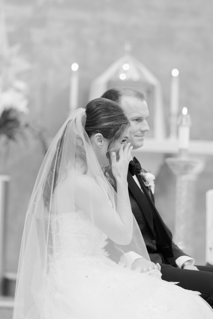 Bride tearing up during wedding ceremony