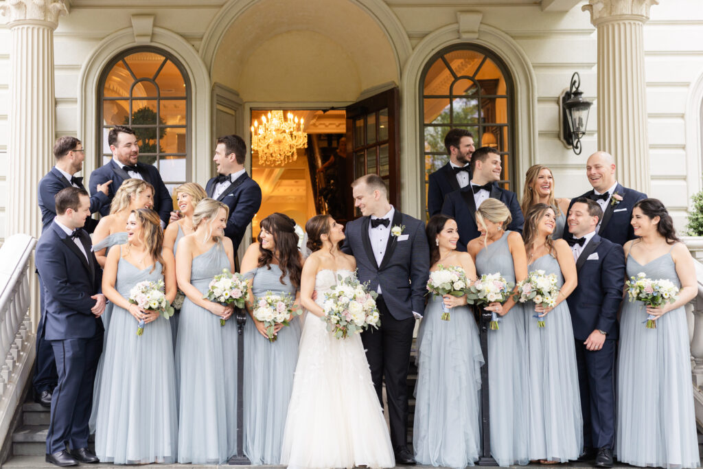 Bride and groom with wedding party in front of Ashford Estate