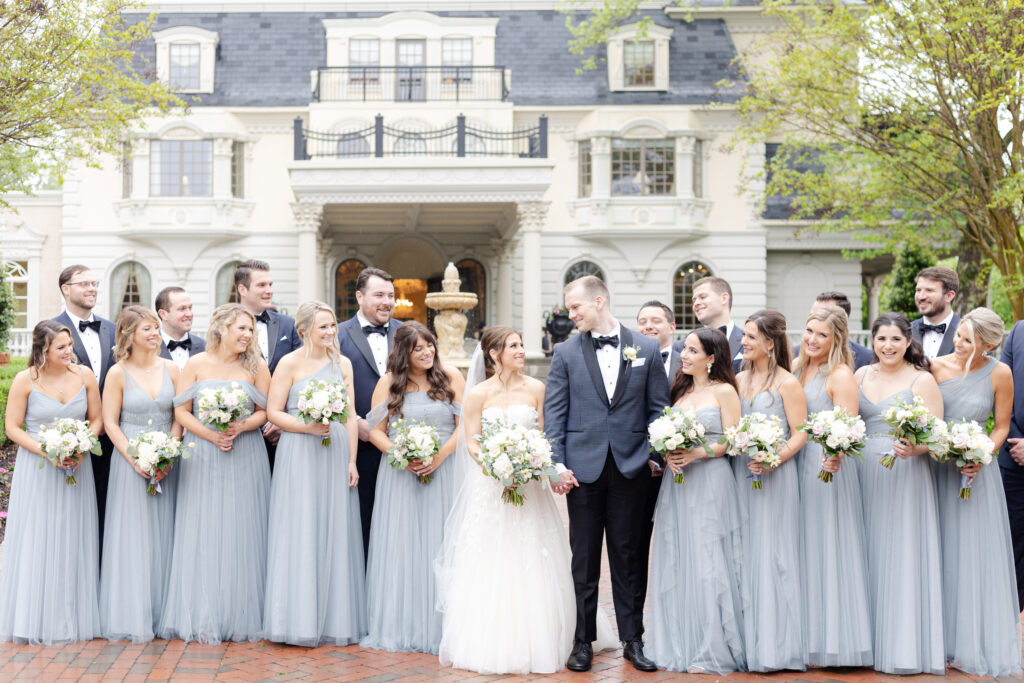 Bride and groom with wedding party in front of Ashford Estate