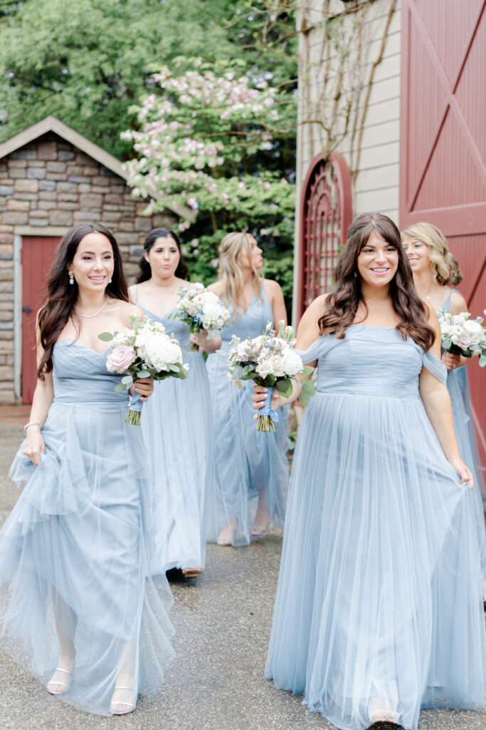 Bridal party walking out of the Red Barn