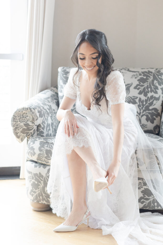 Bride putting wedding heels