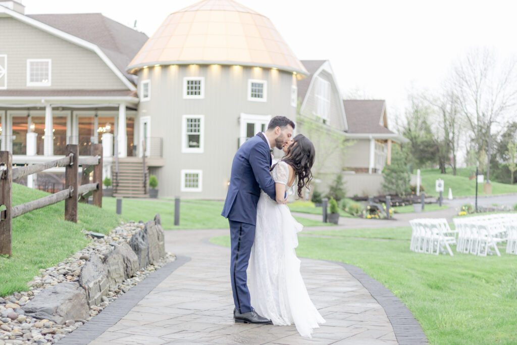 Bride and groom kiss in front of Bear Brook Valley