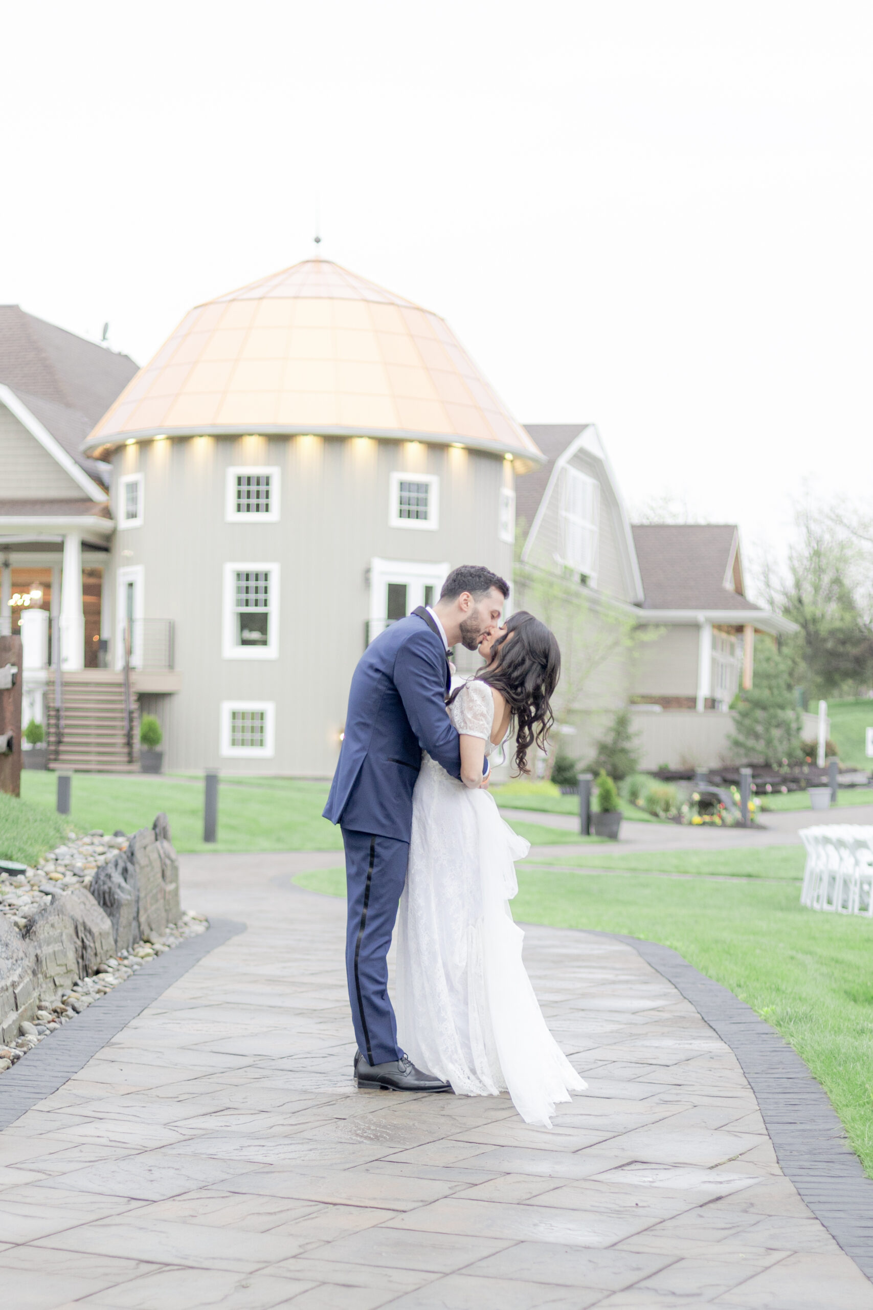 Bride and groom kiss in front of Bear Brook Valley