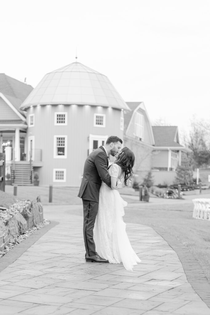 Bride and groom kiss in front of Bear Brook Valley