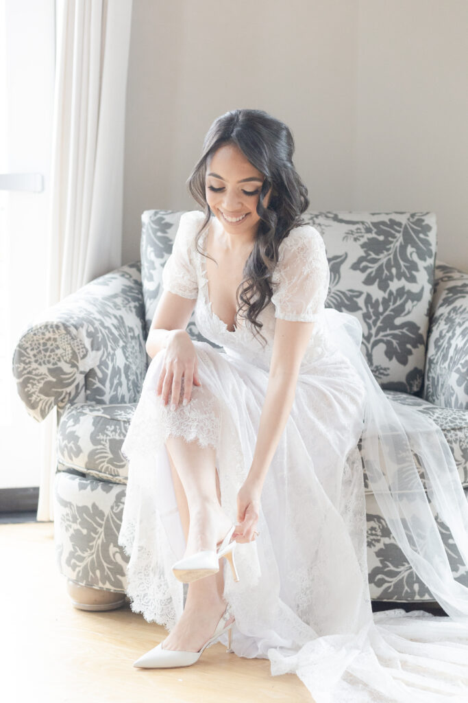 Bride putting wedding heels