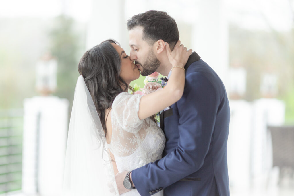 Bride and groom kiss outside of Bear Brook Valley