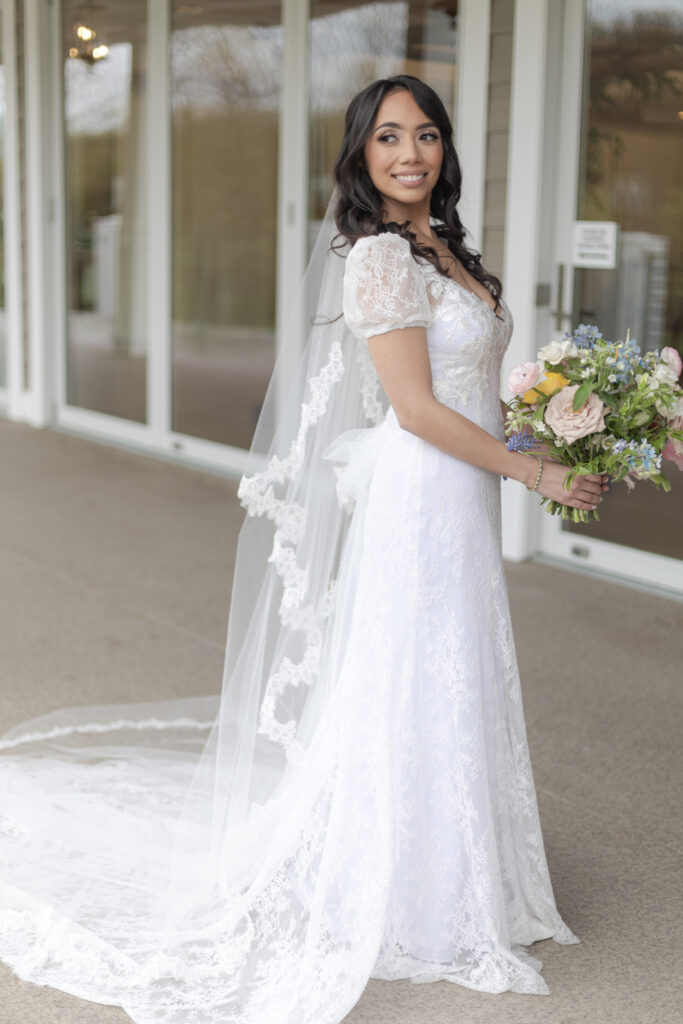 Bride with bouquet outside of Bear Brook Valley Wedding Venue