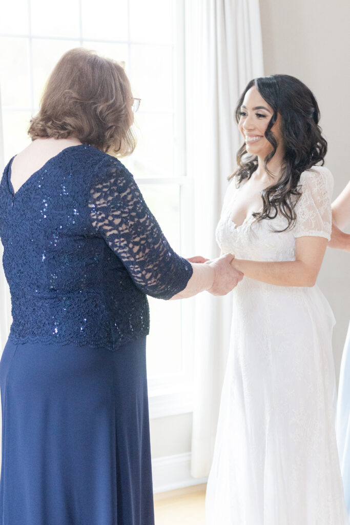 Bride getting dress on inside bridal suite