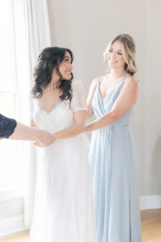 Bride getting dress on inside bridal suite