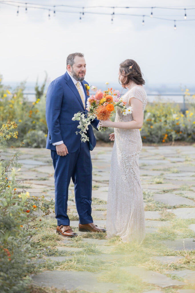 First look moment between bride and groom at Brooklyn rooftop venue