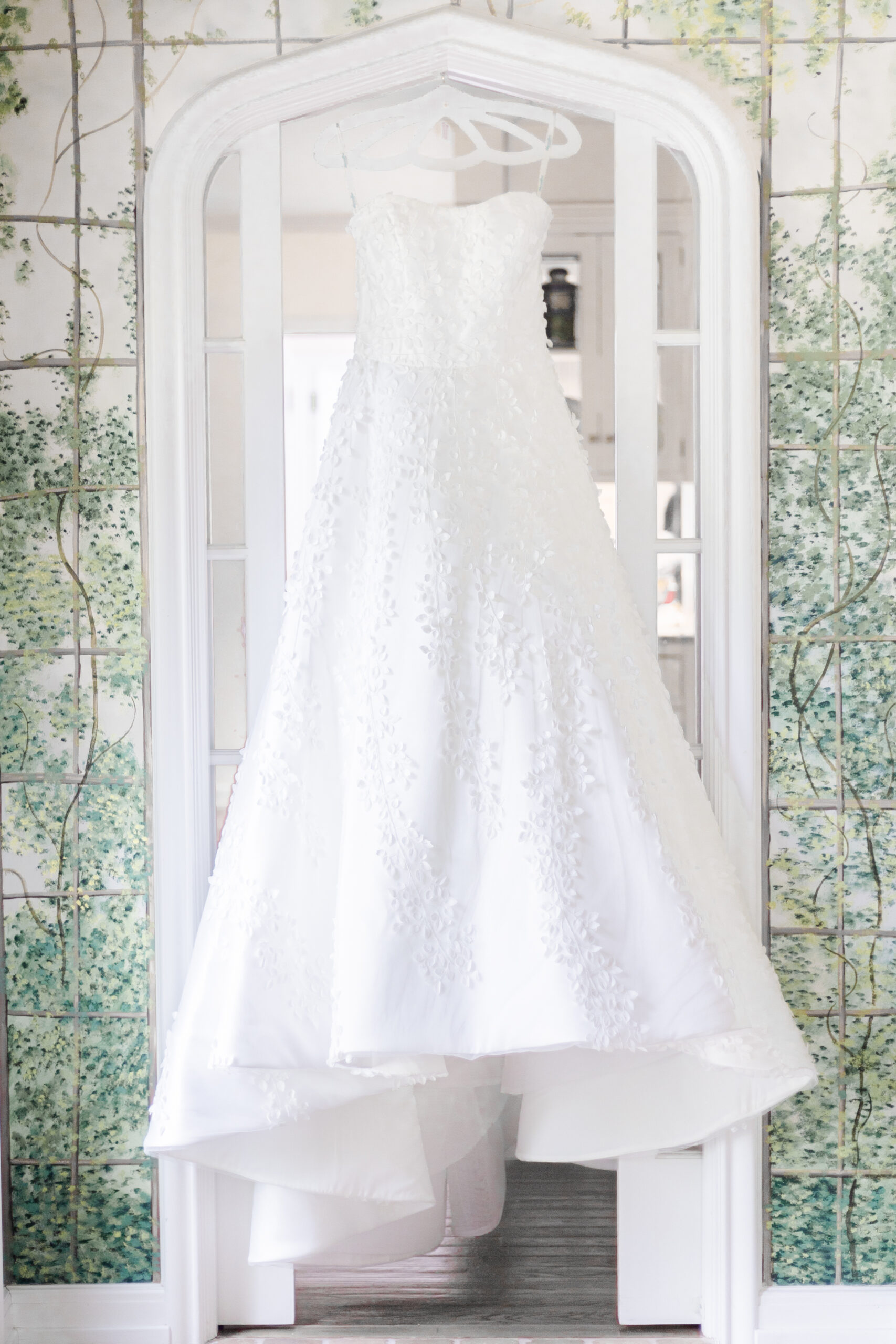 Bride wedding dress on the green floral wall