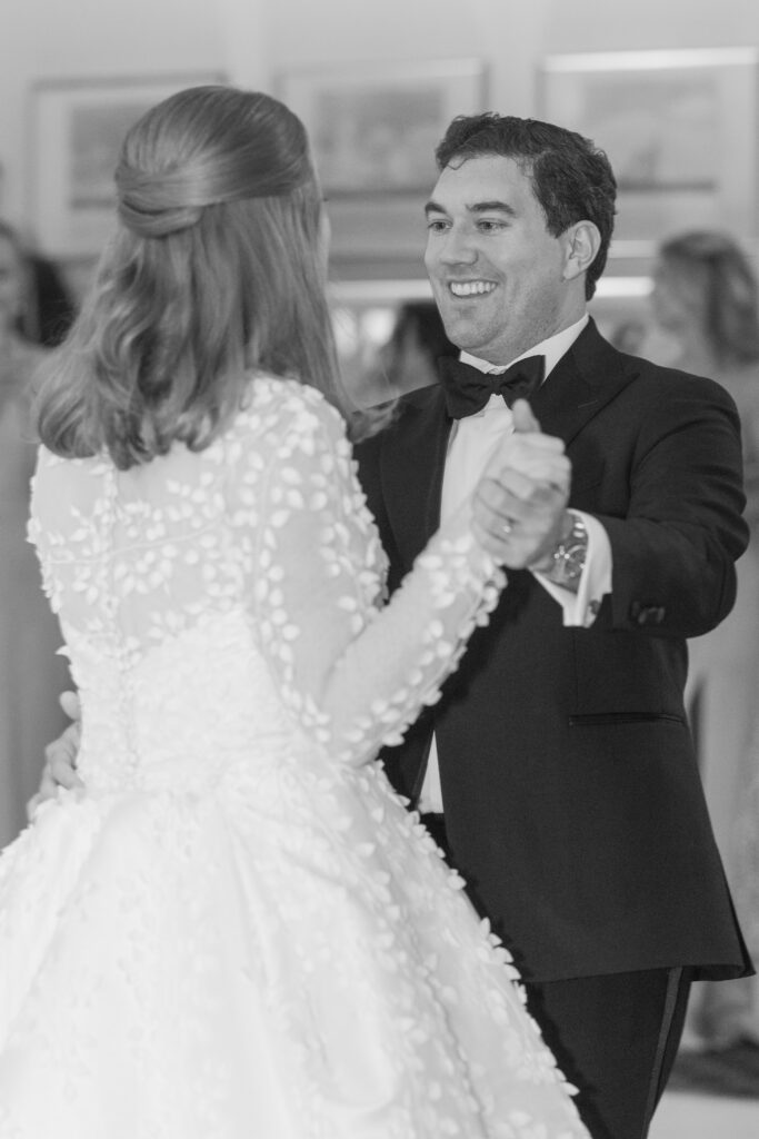 Black and white reception first dance inside Larchmont Yacht Club wedding venue 