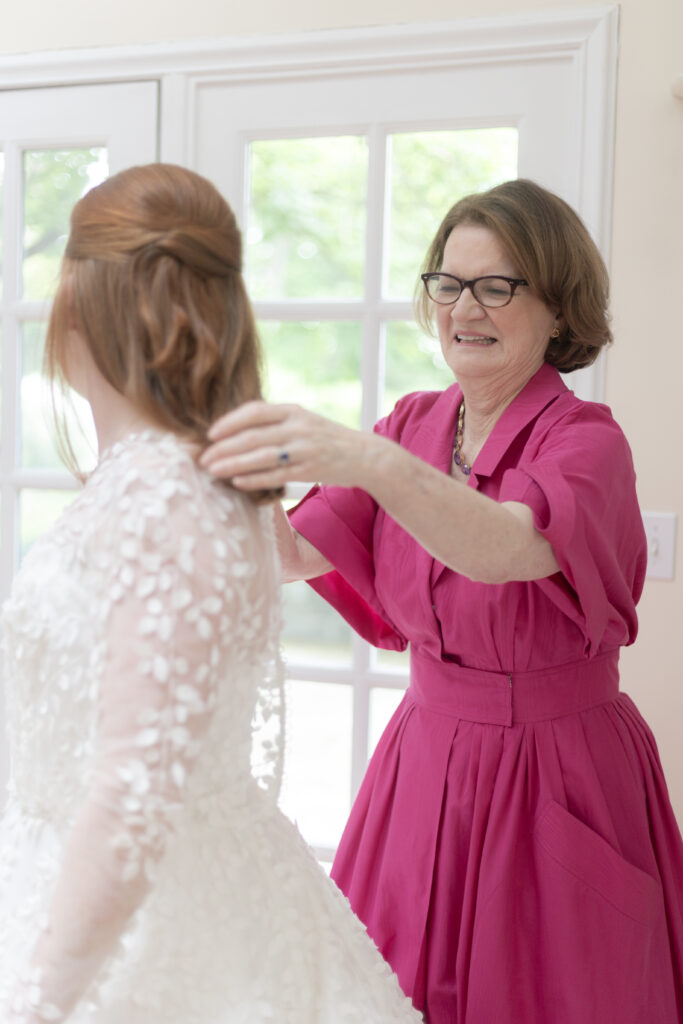 Bride and mom getting bridal sleeves on