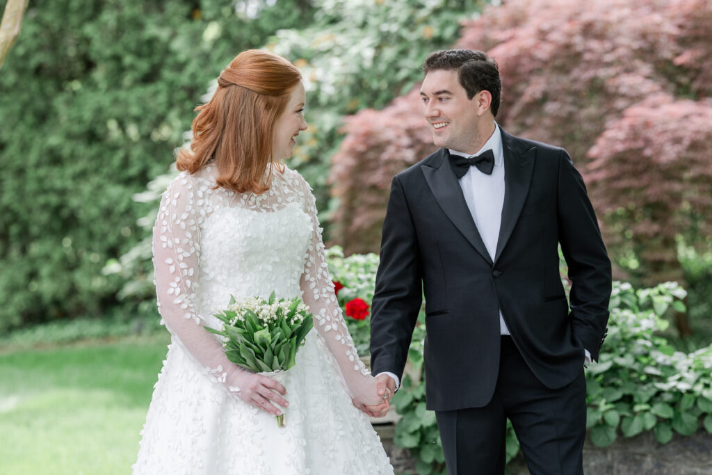 Bride and groom outdoor portrait with greenery background