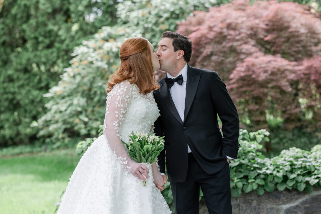 Bride and groom outdoor portrait with greenery background