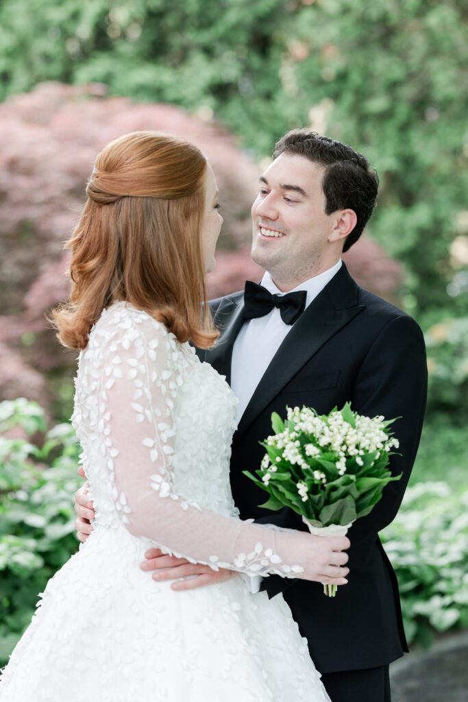 Bride and groom outdoor portrait with greenery background