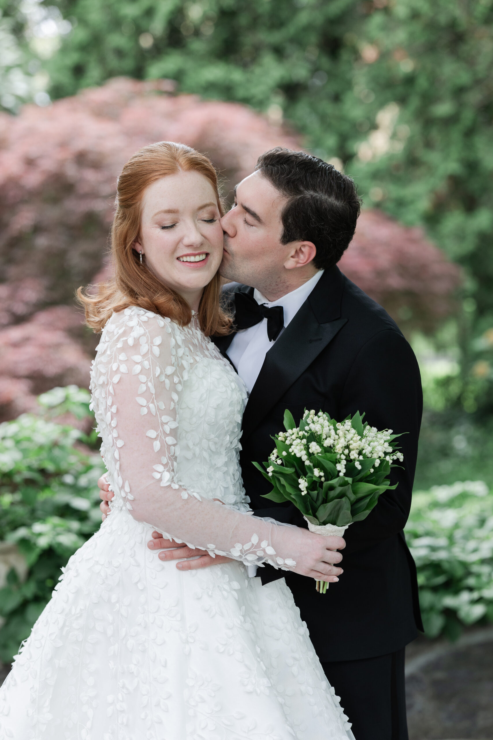 Bride and groom outdoor portrait with greenery background