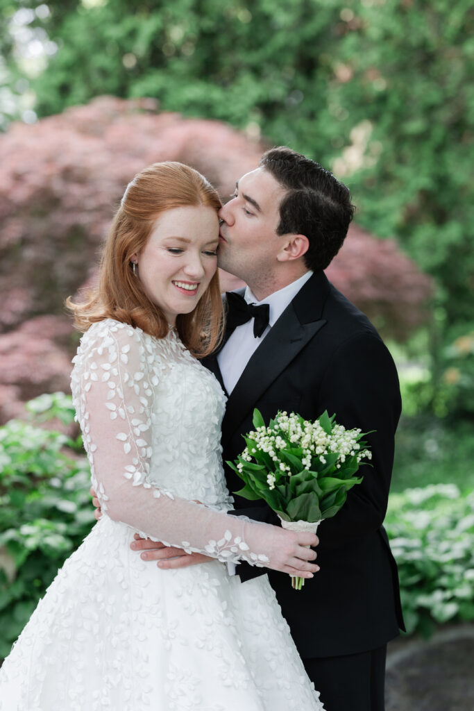 Bride and groom outdoor portrait with greenery background