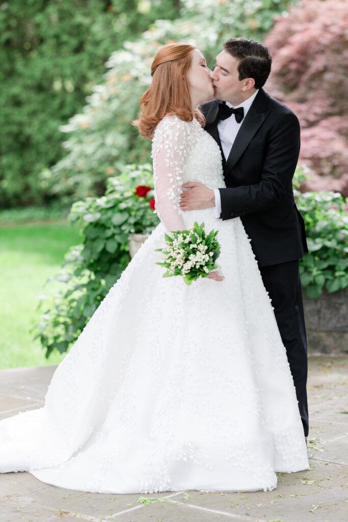 Bride and groom outdoor portrait with greenery background