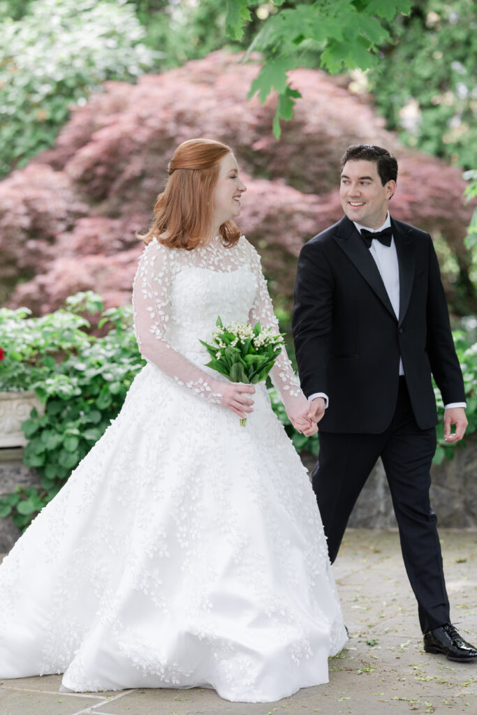 Bride and groom outdoor portrait with greenery background