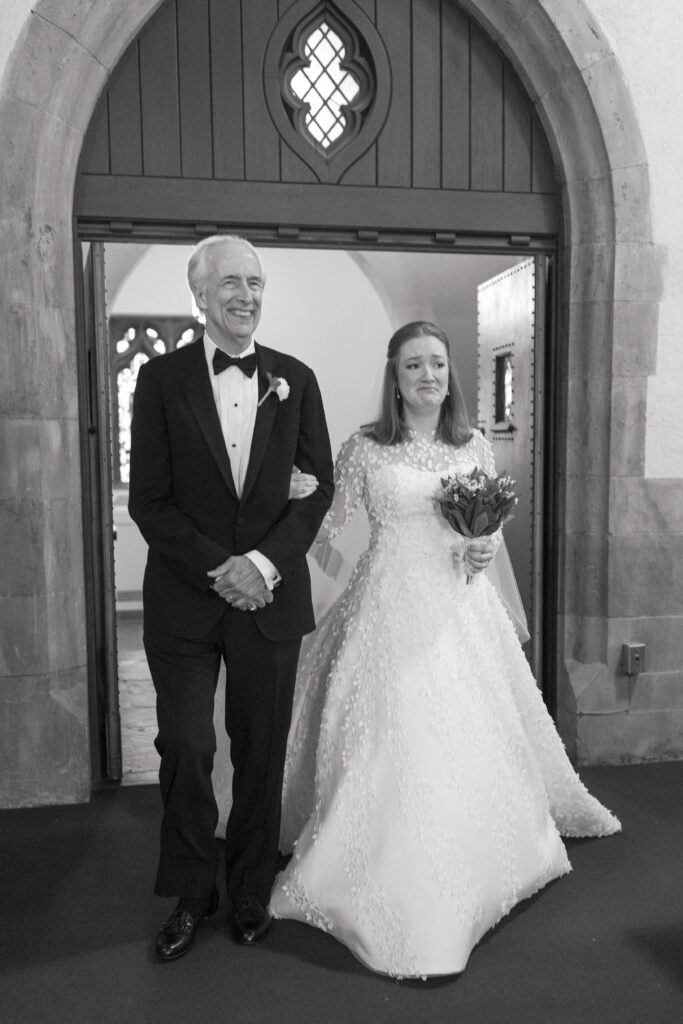 Bride and dad walking down the aisle inside Larchmont church