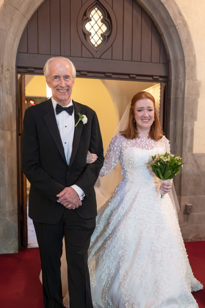 Bride and dad walking down the aisle inside Larchmont church