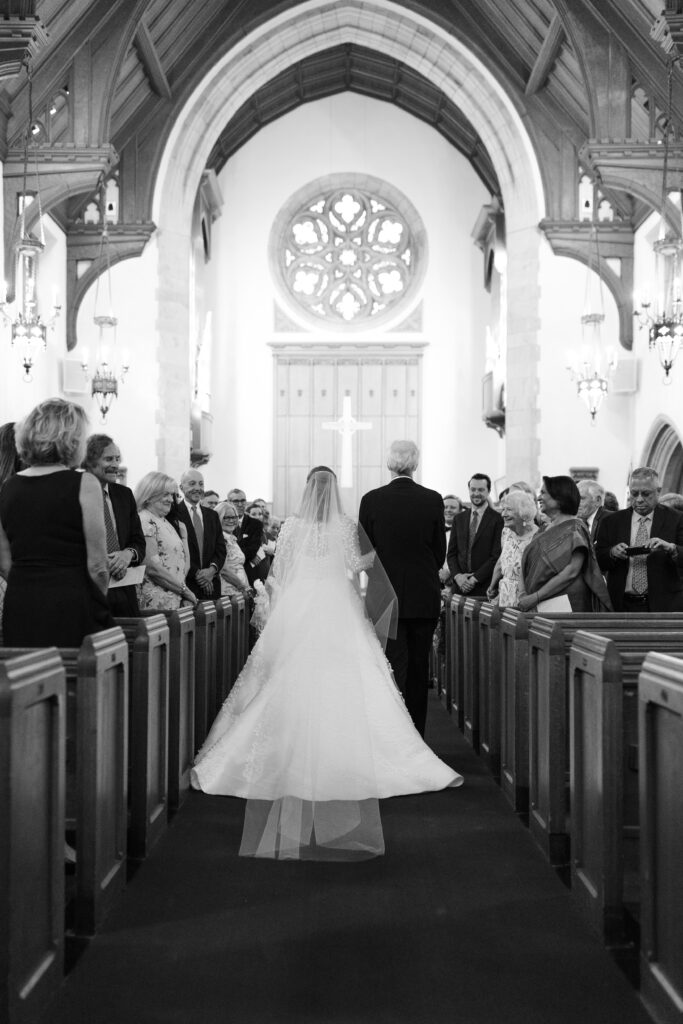 Bride and dad walking down the aisle inside Larchmont church