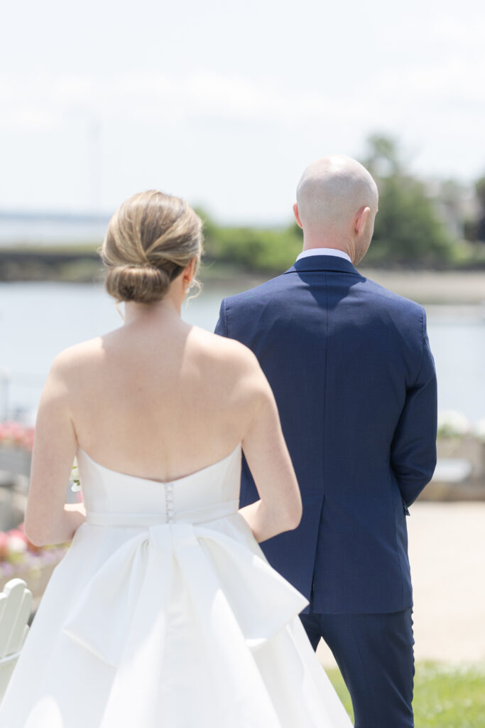 Bride and groom first look outside of yacht club wedding venue