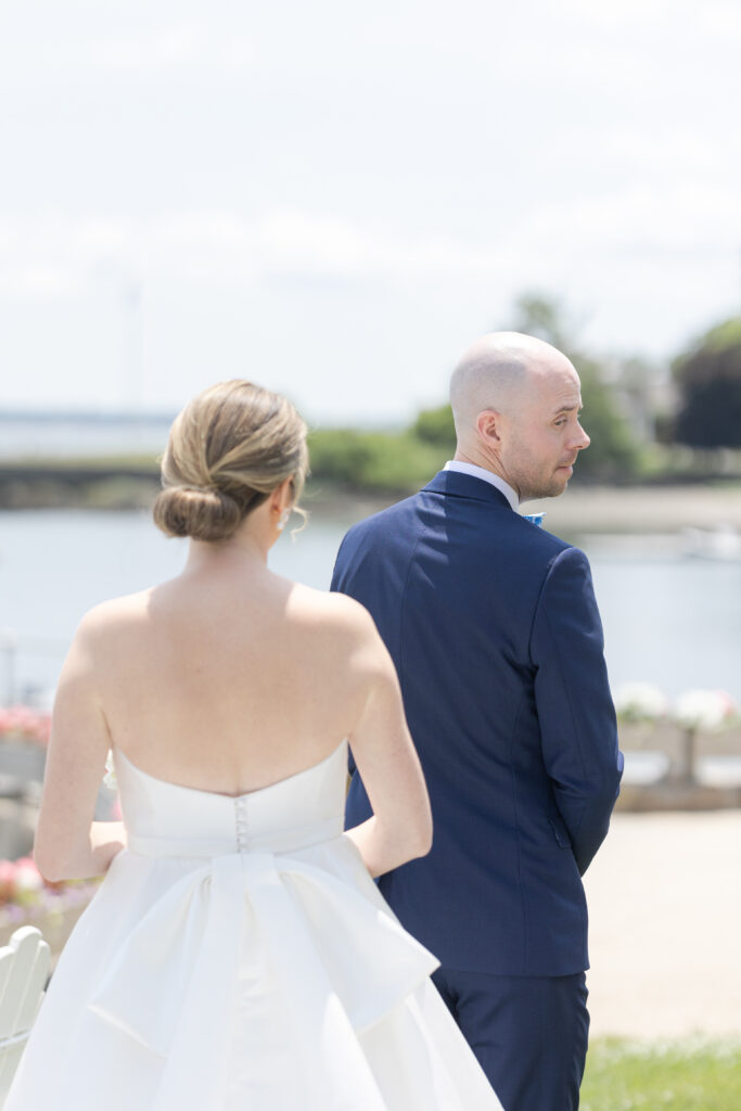 Bride and groom first look outside of yacht club wedding venue