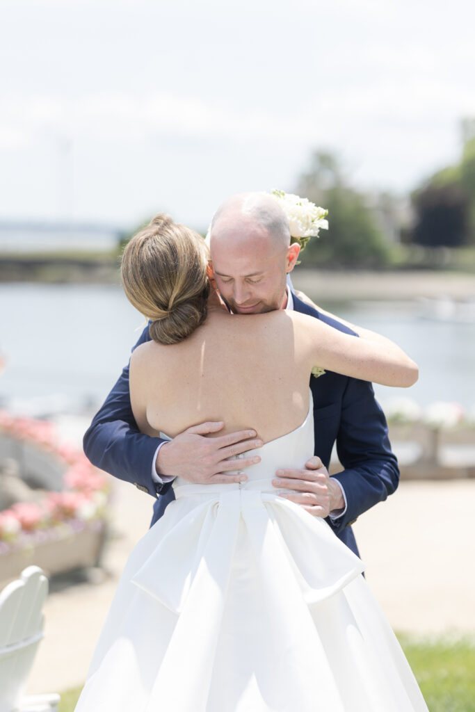 Bride and groom first look in front of waterfront view