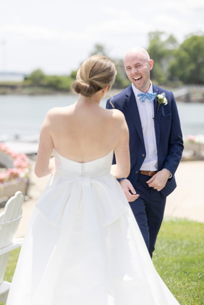 Bride and groom first look in front of waterfront view