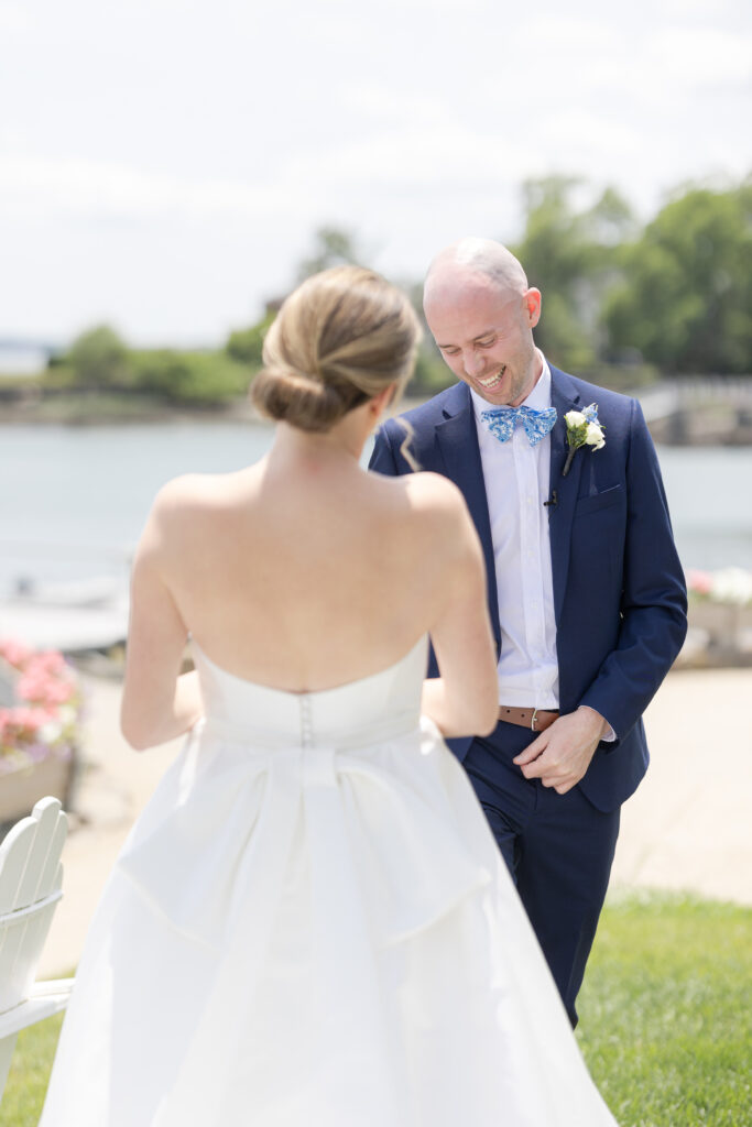 Bride and groom first look in front of waterfront view