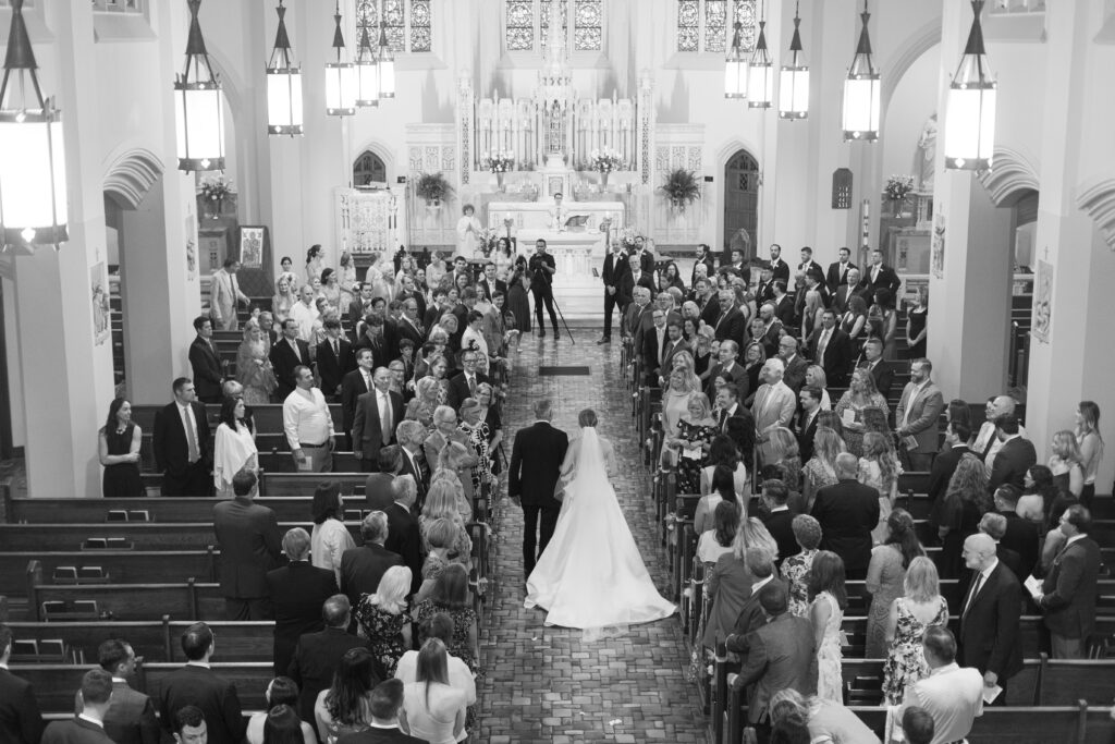 Bride walking down the aisle at church ceremony