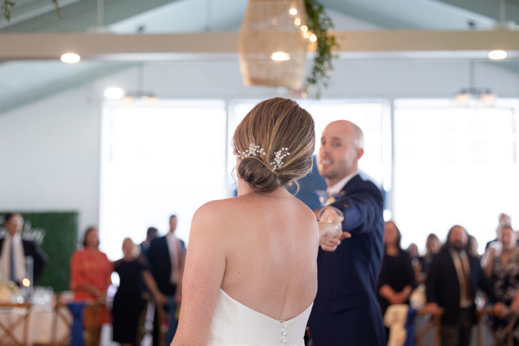 Bride and groom first dance under outdoor tent