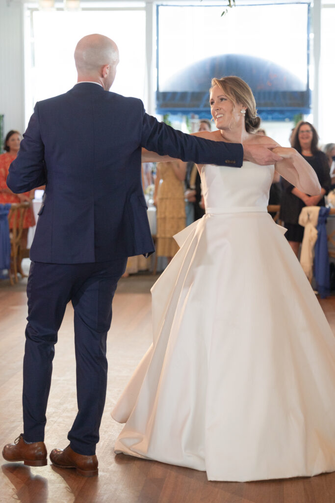 Bride and groom first dance under outdoor tent