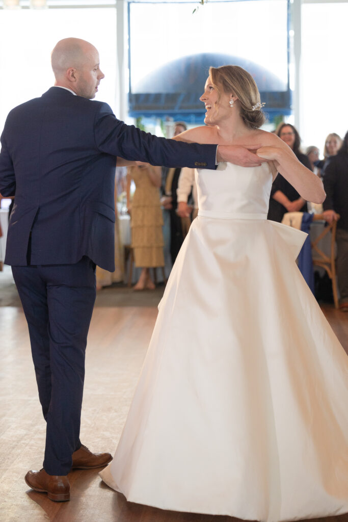 Bride and groom first dance under outdoor tent