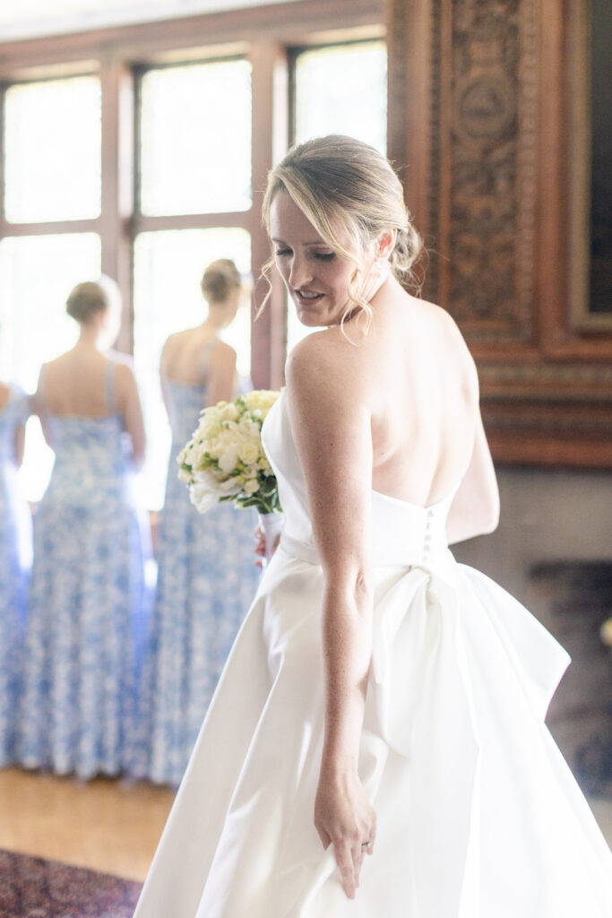 Bride and bridesmaid first look inside yacht club wedding venue bridal suite