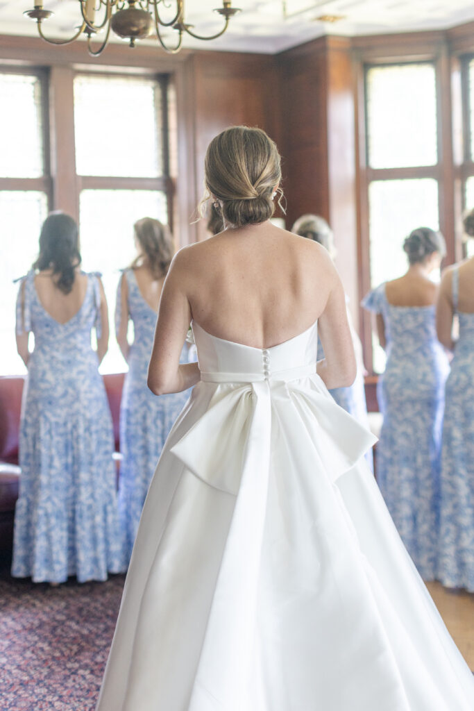 Bride and bridesmaid first look inside yacht club wedding venue bridal suite