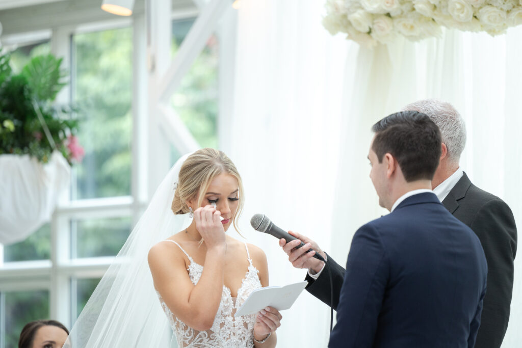 Bride reading vows at wedding ceremony inside NJ Wedding venue