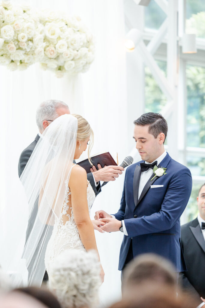 Bride and groom exchanging rings inside NJ Wedding venue