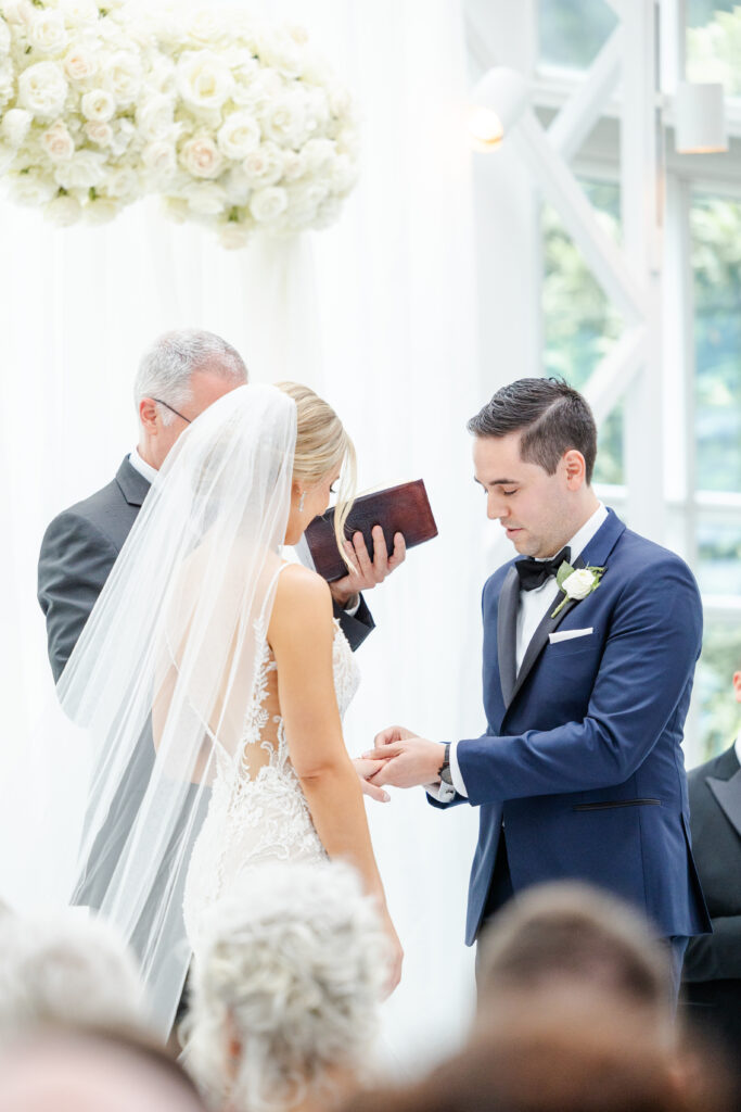 Bride and groom exchanging rings inside NJ Wedding venue