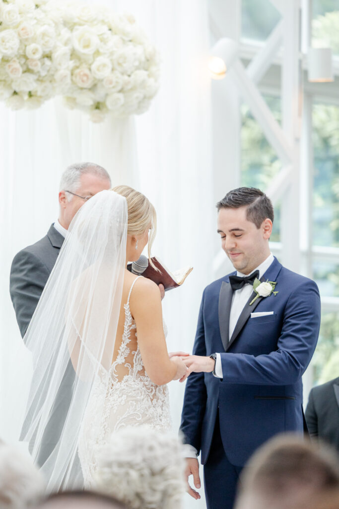 Bride and groom exchanging rings inside NJ Wedding venue