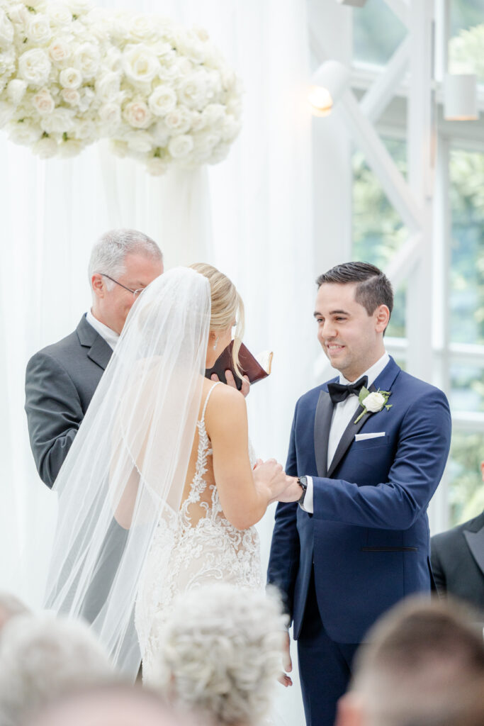 Bride and groom exchanging rings inside NJ Wedding venue